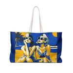 Tote bag with beach scene design featuring two women, palm trees, and a blue sky.